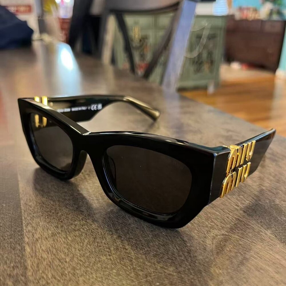 Miu Miu Black Sunglasses with Gold Logo Temples